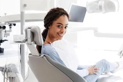woman smiling in the dental chair at Taylor and Associates Family & Implant Dentistry