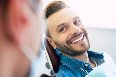 man smiling in the dental chair