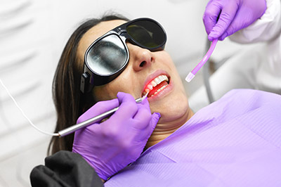 woman getting periodontal treatment at Taylor and Associates Family & Implant Dentistry