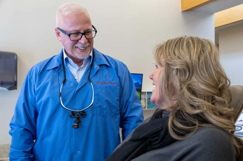 Dr. Taylor smiling at a patient as part of our preventive dentistry in Bay City, MI at Taylor And Associates.
